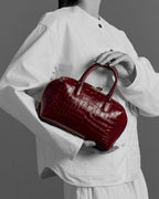 Model with the BOMBAY Ruby Red bag
