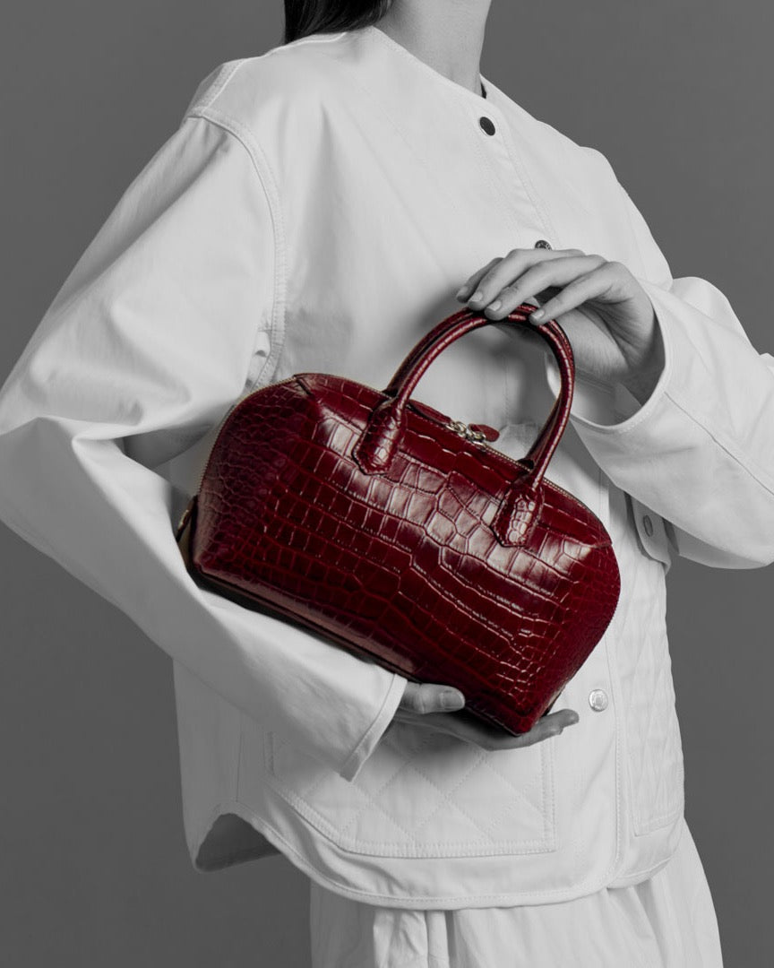 Model with the BOMBAY Ruby Red bag