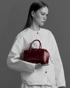 Model with the BOMBAY Ruby Red bag