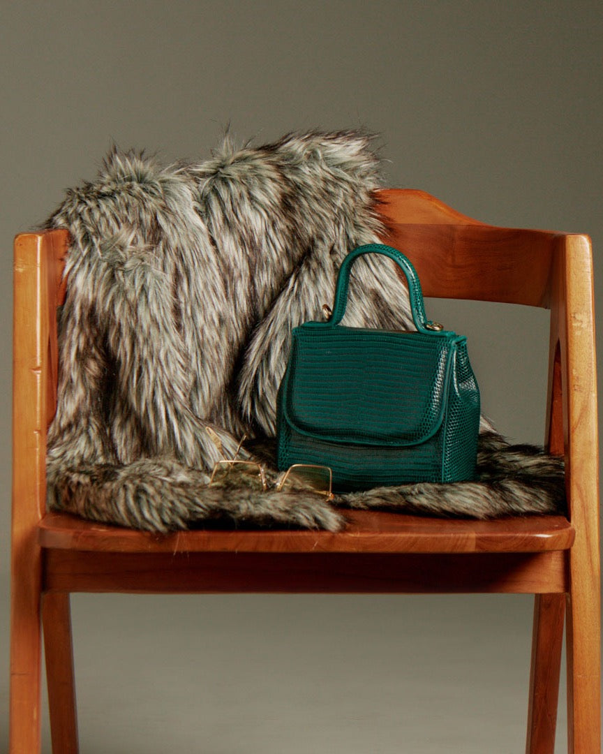 FLORENCE Lizard Dark Green bag on a wooden chair