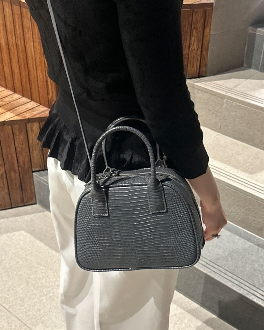 Model with the LUCCA Lizard Mink Grey bag